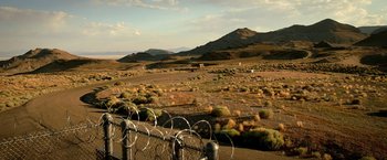 Movie still from “Need for Speed” (2014), directed by Scott Waugh – A fence that is in the middle of a field; Extreme Wide shot, High angle
