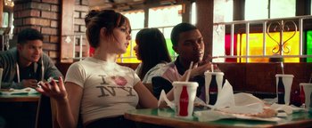 Movie still from “Nerve” (2016), directed by Henry Joost – A group of people sitting at a table with drinks; Medium shot, Over the shoulder angle