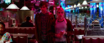 Movie still from “Nerve” (2016), directed by Henry Joost – A man and a woman standing next to each other; Medium shot, Low angle