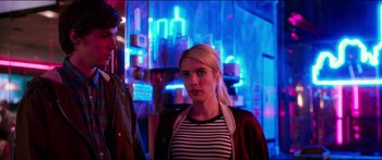Movie still from “Nerve” (2016), directed by Henry Joost – A woman standing next to a man in a dark room; Medium shot, Over the shoulder angle