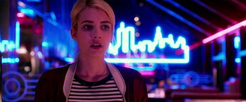 Movie still from “Nerve” (2016), directed by Henry Joost – A woman standing in front of a neon sign at night; Close Up shot, Over the shoulder angle