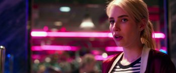 Movie still from “Nerve” (2016), directed by Henry Joost – A young woman is standing in front of a neon sign; Close Up shot, Over the shoulder angle