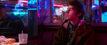 Movie still from “Nerve” (2016), directed by Henry Joost – A man sitting in front of a window at night; Close Up shot, Over the shoulder angle