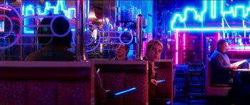 Movie still from “Nerve” (2016), directed by Henry Joost – Two people sitting at a booth in a neon lit restaurant; Medium shot, Over the shoulder angle