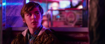 Movie still from “Nerve” (2016), directed by Henry Joost – A man sitting on top of a bench in a room; Close Up shot, Over the shoulder angle