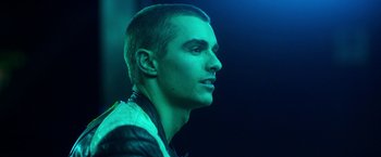 Movie still from “Nerve” (2016), directed by Henry Joost – A man with a shaved head is looking to his left; Close Up shot, Low angle