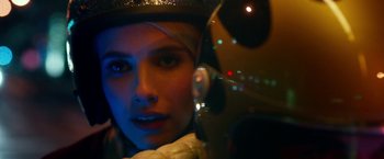 Movie still from “Nerve” (2016), directed by Henry Joost – A woman wearing headphones and looking at the camera; Close Up shot, Over the shoulder angle
