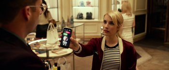 Movie still from “Nerve” (2016), directed by Henry Joost – A woman holding up a cell phone in front of her face; Close Up shot, Over the shoulder angle