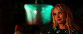Movie still from “Nerve” (2016), directed by Henry Joost – A beautiful blonde woman in a green sequined dress; Close Up shot, Over the shoulder angle