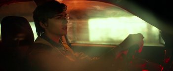 Movie still from “Nerve” (2016), directed by Henry Joost – A young man driving a car in the dark; Close Up shot, Over the shoulder angle