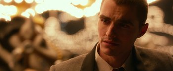 Movie still from “Nerve” (2016), directed by Henry Joost – A person wearing a suit and tie; Close Up shot, Over the shoulder angle