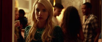 Movie still from “Nerve” (2016), directed by Henry Joost – A woman in a sequined green dress looking at the camera; Close Up shot, Over the shoulder angle