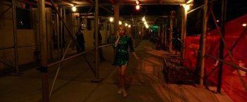 Movie still from “Nerve” (2016), directed by Henry Joost – A woman in a green sequined dress talking on a cell phone; Wide shot, High angle