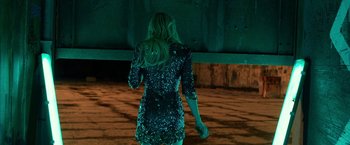 Movie still from “Nerve” (2016), directed by Henry Joost – A woman in a black dress is walking on the street; Medium shot, Low angle