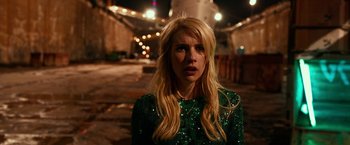Movie still from “Nerve” (2016), directed by Henry Joost – A woman in a sequined green dress standing in the street; Close Up shot, High angle