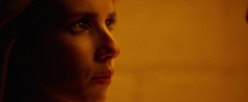 Movie still from “Nerve” (2016), directed by Henry Joost – A person's face in a dimly - lit room; Extreme Close Up shot, Over the shoulder angle