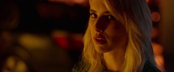 Movie still from “Nerve” (2016), directed by Henry Joost – A beautiful blonde woman with a serious look; Close Up shot, Over the shoulder angle