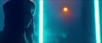 Movie still from “Nerve” (2016), directed by Henry Joost – A woman standing in front of a neon light; Close Up shot, Low angle