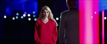 Movie still from “Nerve” (2016), directed by Henry Joost – A woman in a red sweatshirt is looking at a man; Medium shot, Over the shoulder angle