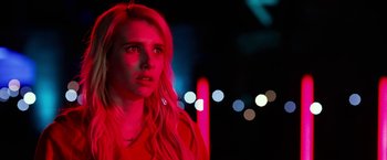 Movie still from “Nerve” (2016), directed by Henry Joost – A woman with long blonde hair standing in a dark room; Close Up shot, Over the shoulder angle