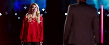 Movie still from “Nerve” (2016), directed by Henry Joost – A woman in a red sweatshirt standing in front of a man; Medium shot, Over the shoulder angle