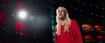 Movie still from “Nerve” (2016), directed by Henry Joost – A woman in a red dress is on a stage; Medium shot, Low angle