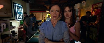 Movie still from “Nerve” (2016), directed by Henry Joost – A woman and a woman standing next to each other in a room; Close Up shot, Over the shoulder angle