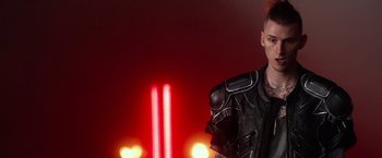 Movie still from “Nerve” (2016), directed by Henry Joost – A man in a leather jacket standing in front of lights; Close Up shot, Low angle