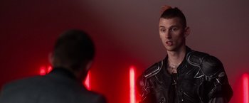 Movie still from “Nerve” (2016), directed by Henry Joost – A man in a black leather jacket standing next to another man in a black leather jacket; Close Up shot, Over the shoulder angle