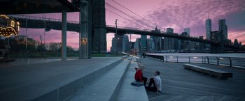 Movie still from “Nerve” (2016), directed by Henry Joost – A man and a woman sitting on a ledge near a bridge; Extreme Wide shot, High angle