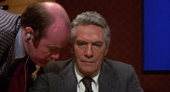 Movie still from “Network” (1976), directed by Sidney Lumet – A man in a business suit and a man in a suit; Close Up shot, Over the shoulder angle