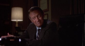 Movie still from “Network” (1976), directed by Sidney Lumet – An older man sitting in a chair in a room; Close Up shot, Over the shoulder angle