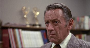 Movie still from “Network” (1976), directed by Sidney Lumet – An older man in a suit and tie looking to his left; Close Up shot, Over the shoulder angle