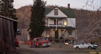 Movie still from “Network” (1976), directed by Sidney Lumet – A red pick up truck parked in front of a white house; Wide shot, Low angle