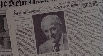 Movie still from “Network” (1976), directed by Sidney Lumet – An old newspaper with a picture of a man in a business suit; Extreme Close Up shot, Overhead angle