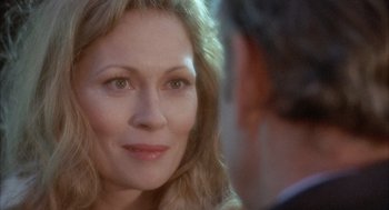 Movie still from “Network” (1976), directed by Sidney Lumet – A woman's face as a man looks on; Close Up shot, Over the shoulder angle