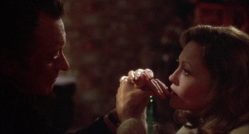 Movie still from “Network” (1976), directed by Sidney Lumet – A man and a woman are eating food together; Close Up shot, Over the shoulder angle