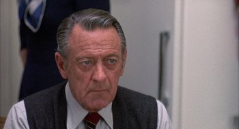 Movie still from “Network” (1976), directed by Sidney Lumet – An older man wearing a vest and a tie; Close Up shot, Over the shoulder angle