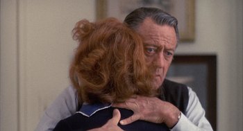 Movie still from “Network” (1976), directed by Sidney Lumet – An older man hugging a younger woman in front of a mirror; Close Up shot, Over the shoulder angle
