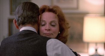 Movie still from “Network” (1976), directed by Sidney Lumet – An older man and a woman embracing each other; Close Up shot, Over the shoulder angle