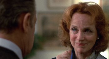 Movie still from “Network” (1976), directed by Sidney Lumet – An older woman with red curly hair looking at a younger man; Close Up shot, Over the shoulder angle