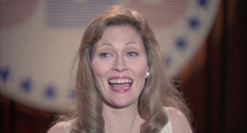 Movie still from “Network” (1976), directed by Sidney Lumet – A person with long brown hair; Close Up shot, High angle