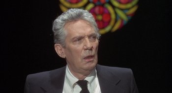 Movie still from “Network” (1976), directed by Sidney Lumet – An older man wearing a suit and tie; Close Up shot, High angle