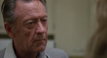 Movie still from “Network” (1976), directed by Sidney Lumet – An older man with a serious look on his face; Close Up shot, Over the shoulder angle