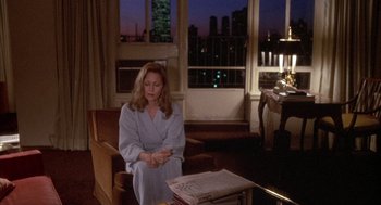 Movie still from “Network” (1976), directed by Sidney Lumet – A woman sitting on a chair in a living room; Medium shot, High angle