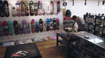 A room filled with skateboards on the wall