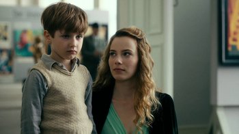 Movie still from “Never Look Away” (2018), directed by Florian Henckel von Donnersmarck – A woman and a young boy standing next to each other; Close Up shot, Over the shoulder angle