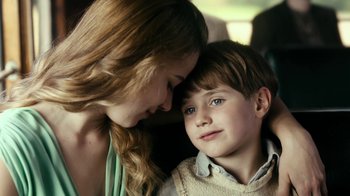 Movie still from “Never Look Away” (2018), directed by Florian Henckel von Donnersmarck – A woman and a boy sitting next to each other on a bus; Close Up shot, Over the shoulder angle