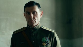 Movie still from “Never Look Away” (2018), directed by Florian Henckel von Donnersmarck – A person wearing a uniform; Close Up shot, Low angle