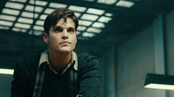 Movie still from “Never Look Away” (2018), directed by Florian Henckel von Donnersmarck – A young man is sitting in front of a window; Close Up shot, Low angle